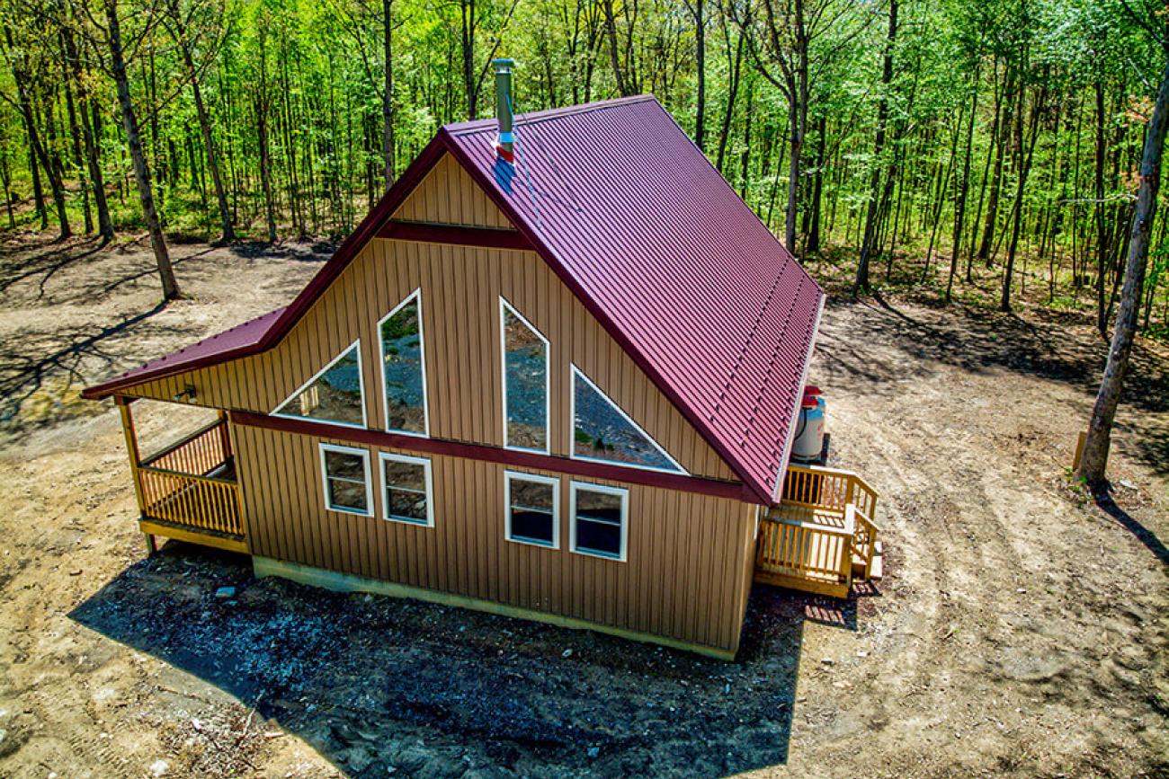 Maroon Metal Roof Cabin Side View